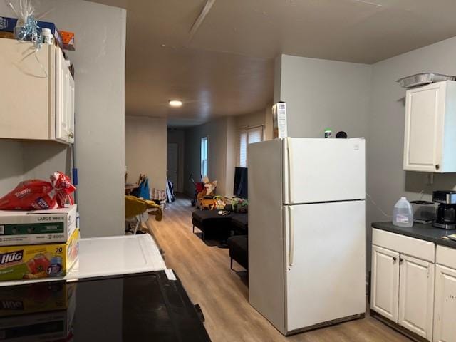 355 Champlain St Unit 353, Rochester, NY 14611 - kitchen featuring freestanding refrigerator, light wood-style flooring, white cabinetry, and dark countertops