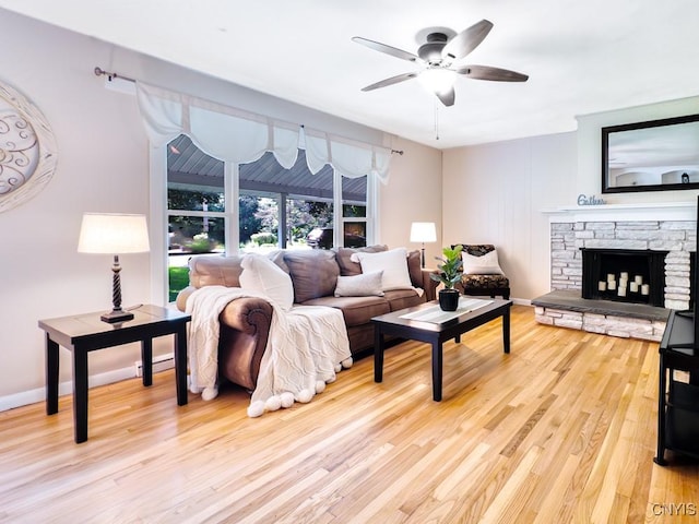 9242 Sixty Rd, Lysander, NY 13135 - living area with light wood-style floors, ceiling fan, and a fireplace