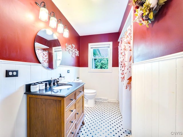 9242 Sixty Rd, Lysander, NY 13135 - full bathroom featuring wainscoting, vanity, and a shower with shower curtain