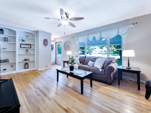 9242 Sixty Rd, Lysander, NY 13135 - living area featuring plenty of natural light, ceiling fan, light wood finished floors, and built in shelves