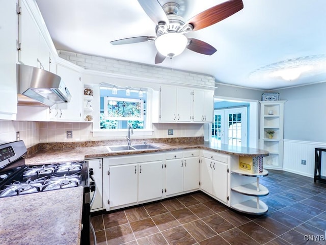 9242 Sixty Rd, Lysander, NY 13135 - kitchen with open shelves, exhaust hood, stainless steel gas range oven, healthy amount of natural light, and wainscoting