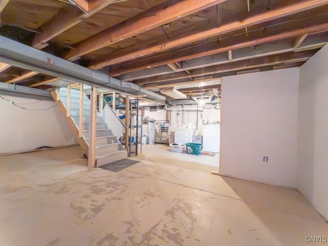 9242 Sixty Rd, Lysander, NY 13135 - unfinished basement featuring stairway and washer and clothes dryer