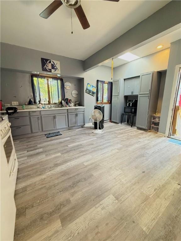 188 5th St, Rochester, NY 14605 - living room with ceiling fan, light wood-style floors, and beamed ceiling