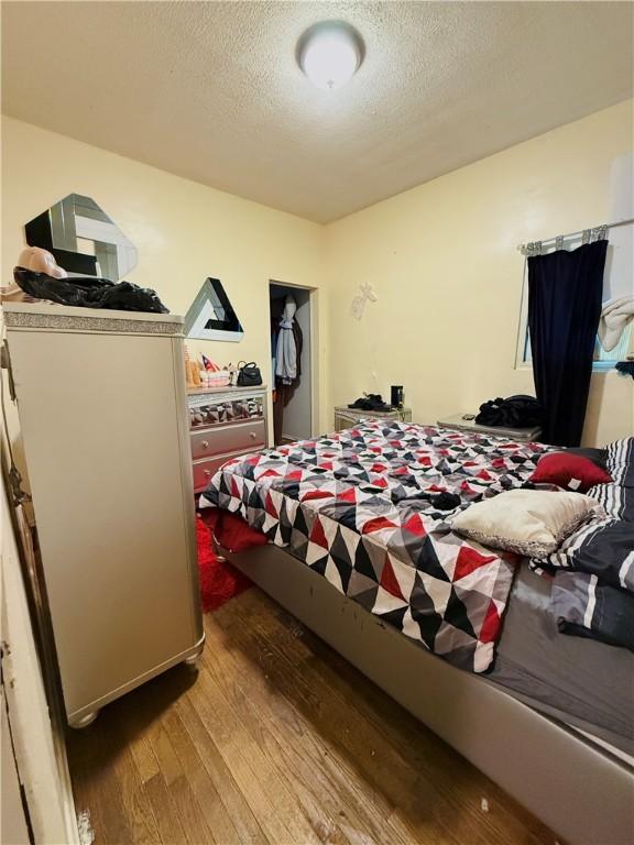 188 5th St, Rochester, NY 14605 - bedroom with hardwood / wood-style flooring and a textured ceiling