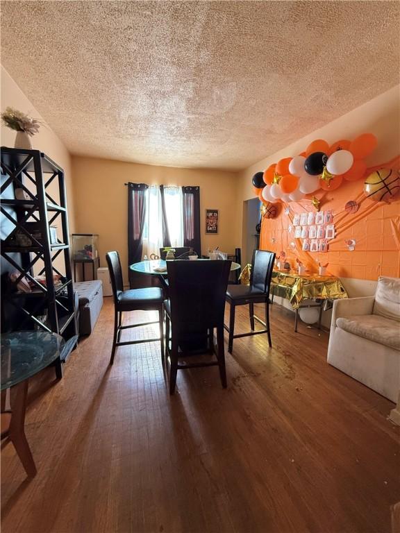 188 5th St, Rochester, NY 14605 - dining area with a textured ceiling and wood finished floors