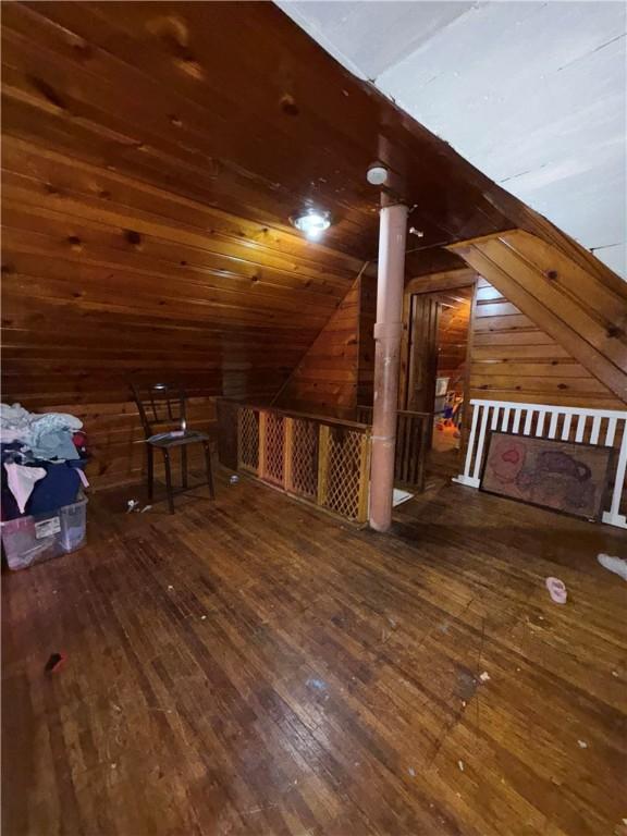 188 5th St, Rochester, NY 14605 - additional living space with hardwood / wood-style floors, lofted ceiling, and wooden walls