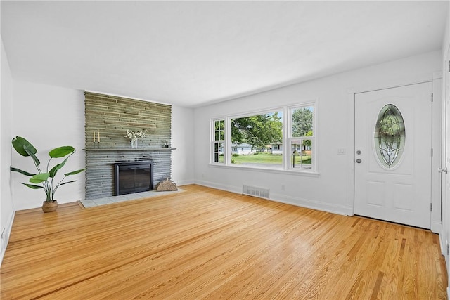 33 W Crest Dr, Gates, NY 14606 - unfurnished living room featuring a fireplace and wood finished floors