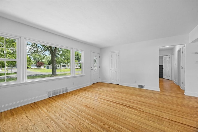 33 W Crest Dr, Gates, NY 14606 - unfurnished living room with light wood finished floors and baseboards