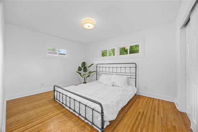 33 W Crest Dr, Gates, NY 14606 - bedroom featuring a closet, multiple windows, and wood finished floors
