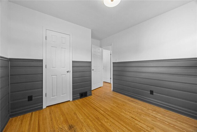 33 W Crest Dr, Gates, NY 14606 - unfurnished bedroom with wainscoting and light wood-type flooring