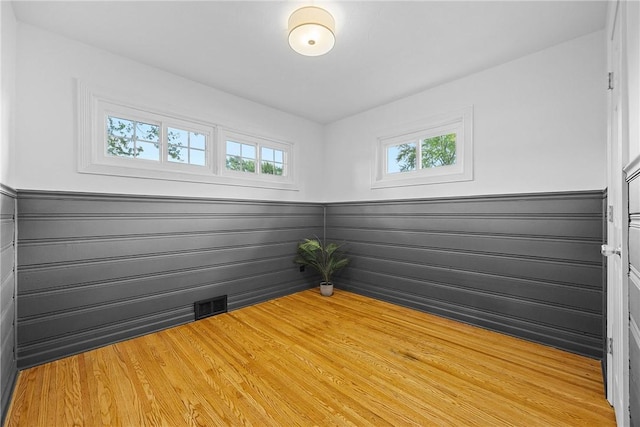 33 W Crest Dr, Gates, NY 14606 - empty room featuring light wood finished floors and a wainscoted wall