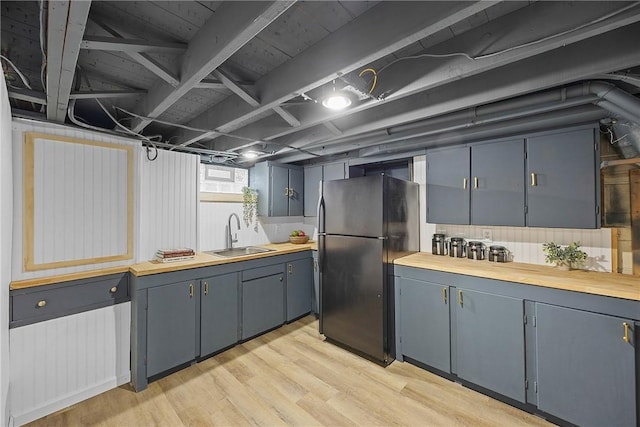 33 W Crest Dr, Gates, NY 14606 - kitchen featuring freestanding refrigerator, light wood finished floors, gray cabinetry, and blue cabinetry