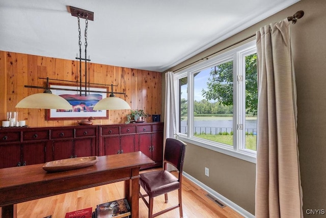 117 Shoreview Dr, Clay, NY 13090 - dining area with wooden walls, light wood-type flooring, and a water view