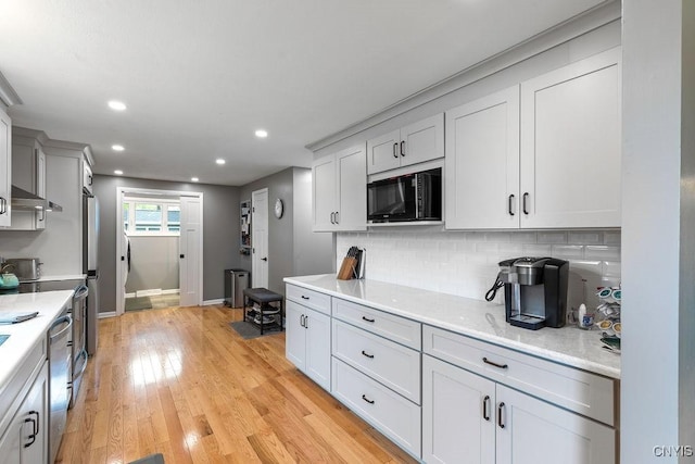 117 Shoreview Dr, Clay, NY 13090 - kitchen with black microwave, dishwasher, backsplash, light wood-type flooring, and recessed lighting