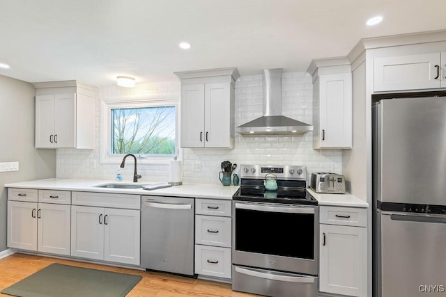 117 Shoreview Dr, Clay, NY 13090 - kitchen featuring appliances with stainless steel finishes, wall chimney range hood, light countertops, tasteful backsplash, and recessed lighting