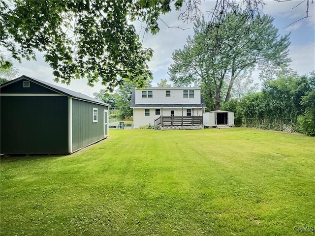 313 Chestnut St, Oswego, NY 13126 - rear view of property featuring a wooden deck and a storage unit