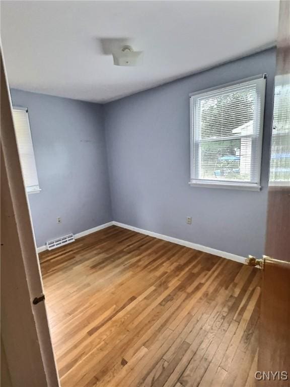 313 Chestnut St, Oswego, NY 13126 - unfurnished room featuring wood finished floors and baseboards