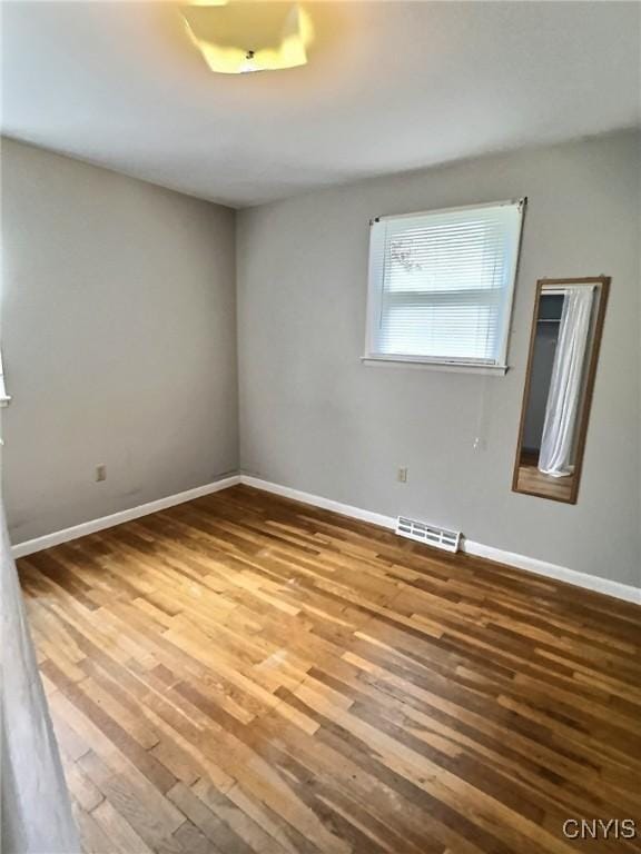 313 Chestnut St, Oswego, NY 13126 - unfurnished room featuring wood finished floors and baseboards