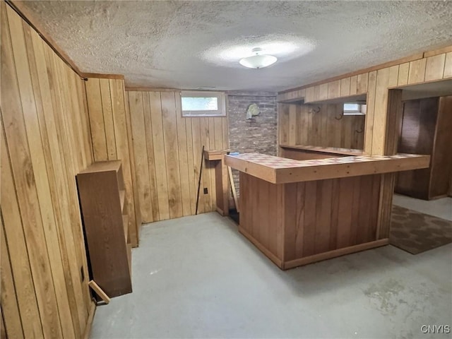 313 Chestnut St, Oswego, NY 13126 - indoor dry bar with wood walls, concrete floors, and a textured ceiling