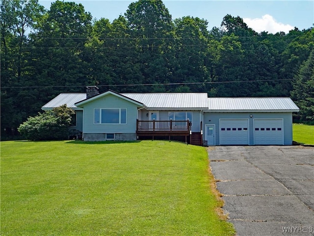 213 Bradshaw Rd, Dryden, NY 13053 - ranch-style house with a garage, driveway, a front lawn, and a metal roof