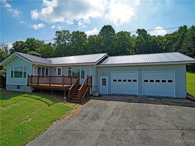 213 Bradshaw Rd, Dryden, NY 13053 - ranch-style house featuring a metal roof, a front lawn, and a deck