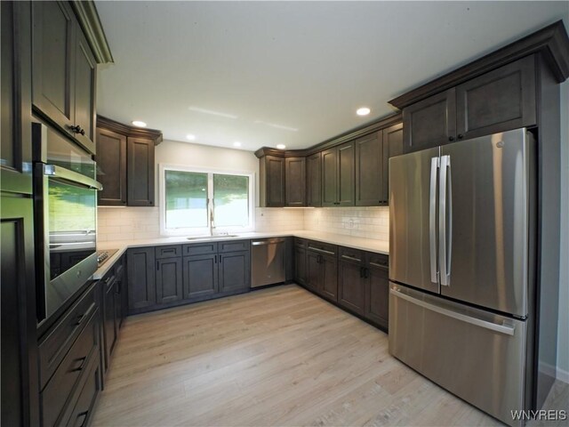 213 Bradshaw Rd, Dryden, NY 13053 - kitchen featuring stainless steel appliances, light wood-type flooring, backsplash, dark brown cabinets, and recessed lighting