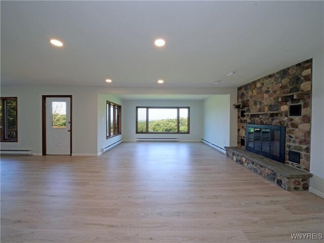 213 Bradshaw Rd, Dryden, NY 13053 - unfurnished living room featuring a baseboard heating unit, plenty of natural light, a baseboard radiator, light wood-style floors, and recessed lighting