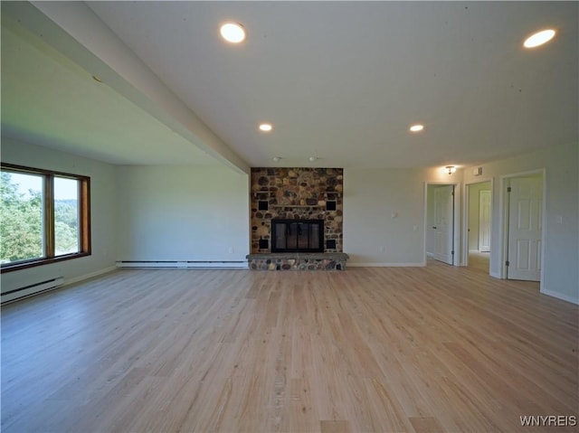 213 Bradshaw Rd, Dryden, NY 13053 - unfurnished living room featuring baseboard heating, light wood-style flooring, recessed lighting, and a stone fireplace