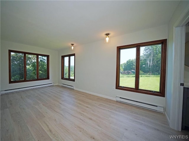 213 Bradshaw Rd, Dryden, NY 13053 - spare room featuring a baseboard heating unit and light wood-style flooring