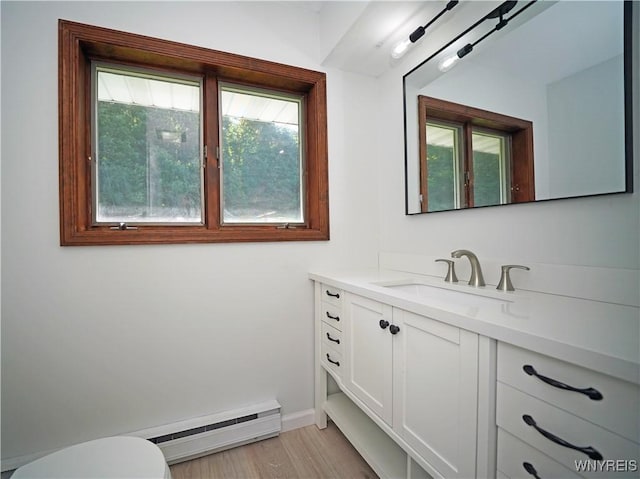 213 Bradshaw Rd, Dryden, NY 13053 - half bath with baseboard heating, vanity, and wood finished floors