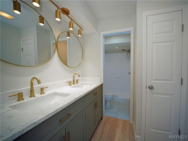 213 Bradshaw Rd, Dryden, NY 13053 - bathroom featuring double vanity, a shower, and wood finished floors
