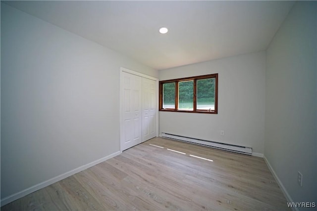 213 Bradshaw Rd, Dryden, NY 13053 - unfurnished bedroom with a baseboard heating unit, light wood-style floors, a closet, and recessed lighting