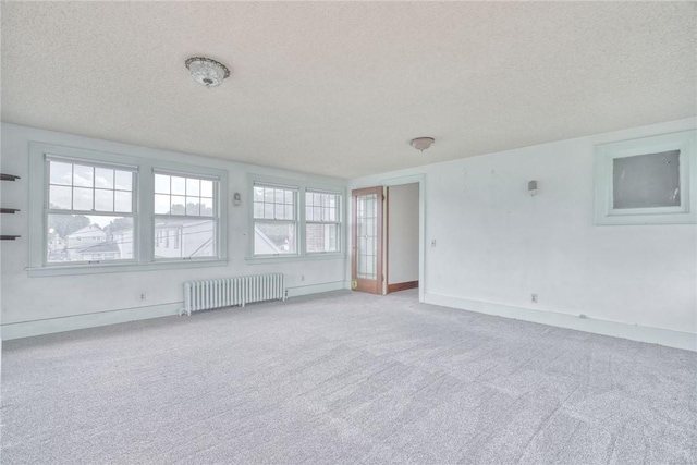 112 Isabelle St, Rochester, NY 14606 - carpeted spare room with radiator heating unit and a textured ceiling