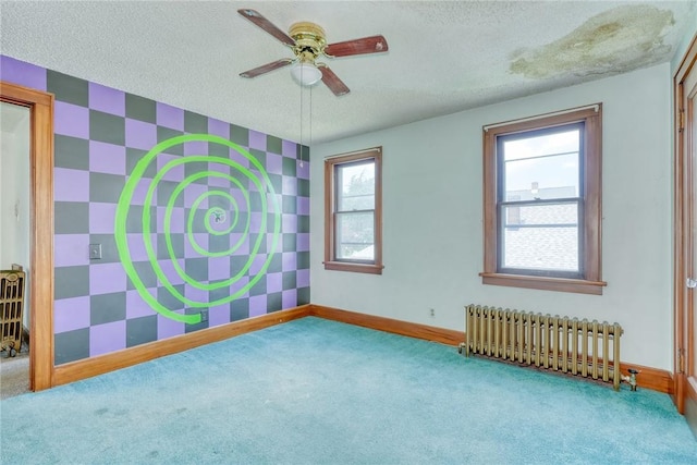 112 Isabelle St, Rochester, NY 14606 - spare room with radiator, carpet flooring, an accent wall, a textured ceiling, and a ceiling fan