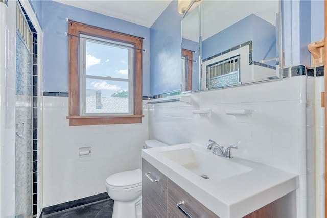 112 Isabelle St, Rochester, NY 14606 - full bath with tile walls, vanity, tile patterned flooring, a shower with door, and wainscoting