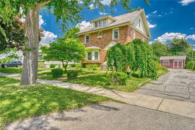 112 Isabelle St, Rochester, NY 14606 - view of front of house featuring a front lawn, brick siding, and an outbuilding