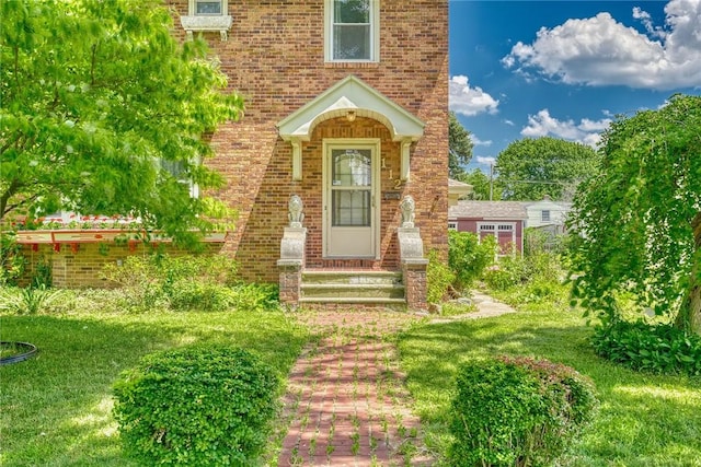 112 Isabelle St, Rochester, NY 14606 - doorway to property featuring brick siding and a lawn
