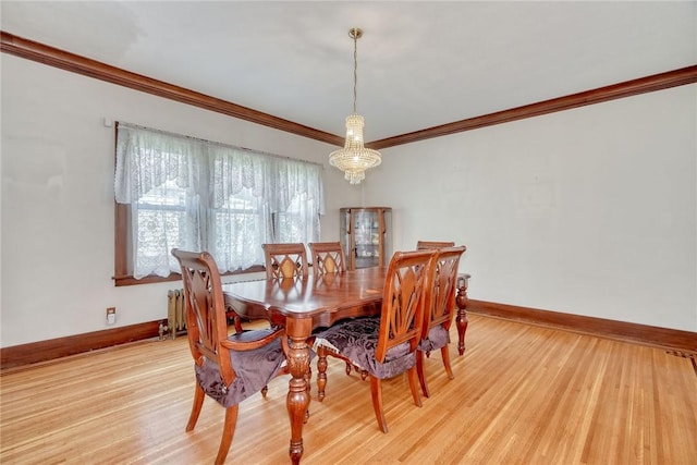 112 Isabelle St, Rochester, NY 14606 - dining room with crown molding, light wood-type flooring, radiator heating unit, and a chandelier