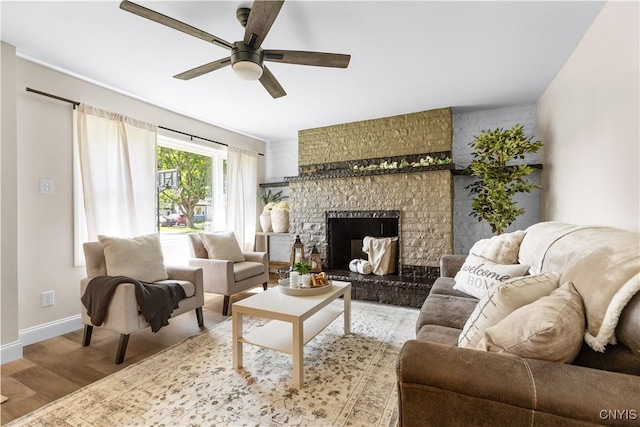 161 Forrest St, Deerfield, NY 13502 - living area featuring wood finished floors, a large fireplace, and ceiling fan