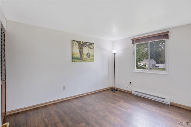 3675 Buttercup Ln, Clay, NY 13027 - empty room featuring a baseboard heating unit and wood finished floors