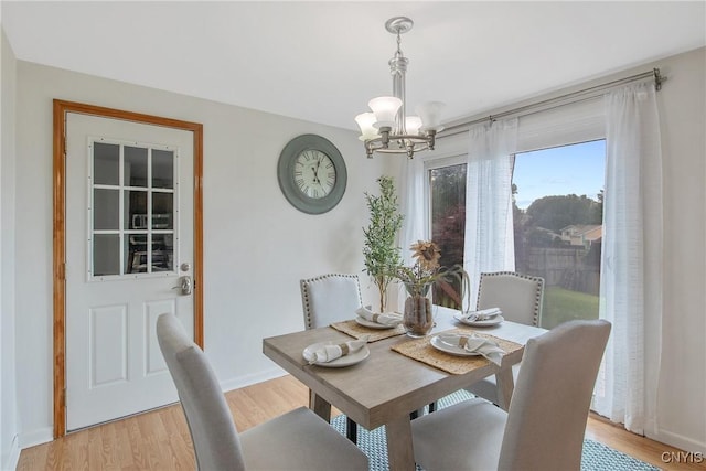 3675 Buttercup Ln, Clay, NY 13027 - dining room with a chandelier and light wood-style flooring
