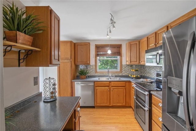 3675 Buttercup Ln, Clay, NY 13027 - kitchen featuring stainless steel appliances, dark countertops, open shelves, light wood-type flooring, and decorative backsplash