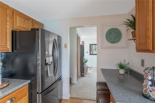 3675 Buttercup Ln, Clay, NY 13027 - kitchen featuring stainless steel refrigerator with ice dispenser, brown cabinets, and light wood-style flooring