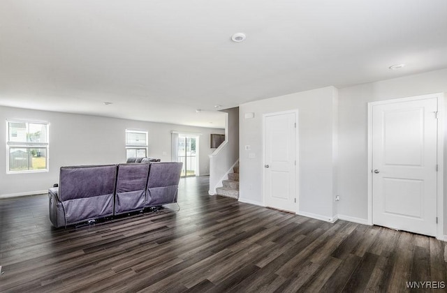 52 Winterbrook Dr, Amherst, NY 14228 - living area with dark wood finished floors, healthy amount of natural light, and stairway
