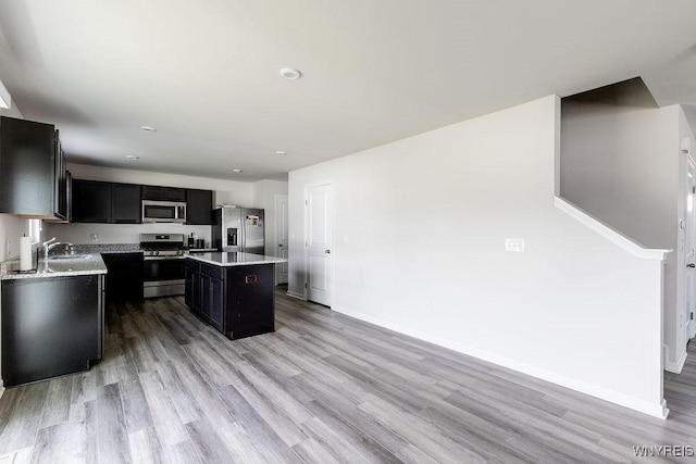 52 Winterbrook Dr, Amherst, NY 14228 - kitchen with stainless steel appliances, dark cabinets, light wood-style flooring, and recessed lighting