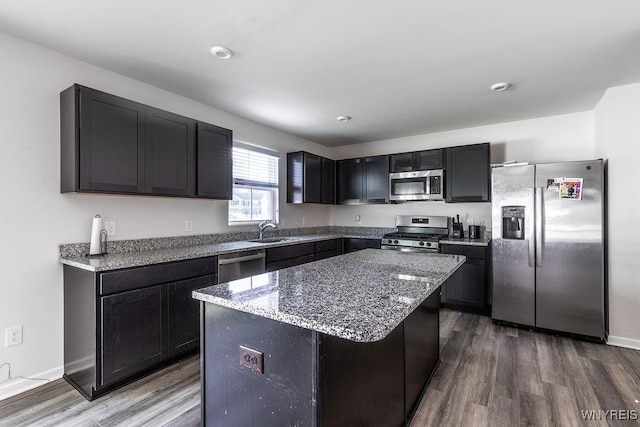 52 Winterbrook Dr, Amherst, NY 14228 - kitchen with stainless steel appliances, light stone countertops, wood finished floors, and a kitchen island
