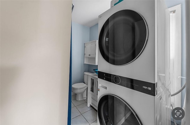 1162 Draper Ave, Elmira, NY 14905 - laundry room featuring stacked washing machine and dryer and light tile patterned flooring