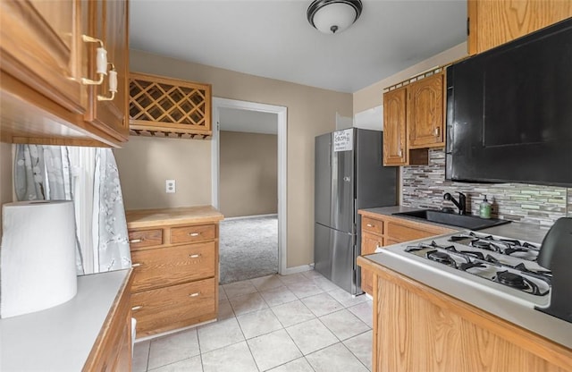 1162 Draper Ave, Elmira, NY 14905 - kitchen with freestanding refrigerator, stove, tasteful backsplash, light tile patterned floors, and light countertops