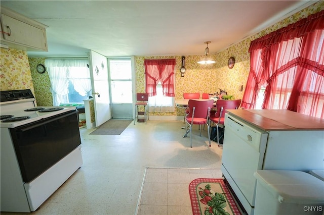 202 County Highway 25a, Richfield, NY 13439 - kitchen featuring white appliances, wallpapered walls, light flooring, healthy amount of natural light, and hanging light fixtures
