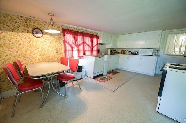 202 County Highway 25a, Richfield, NY 13439 - kitchen with white appliances, wallpapered walls, white cabinetry, decorative light fixtures, and light countertops